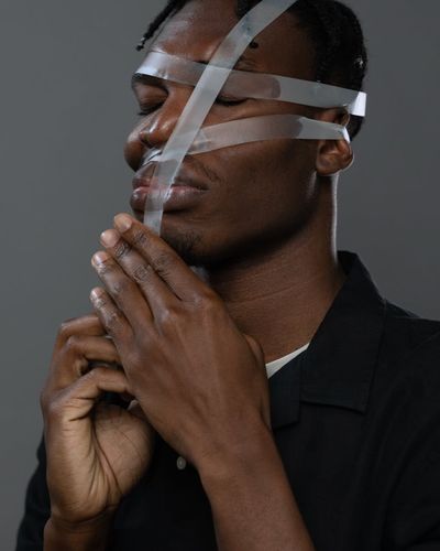 Close-up of a person's hands in a meditative gesture.